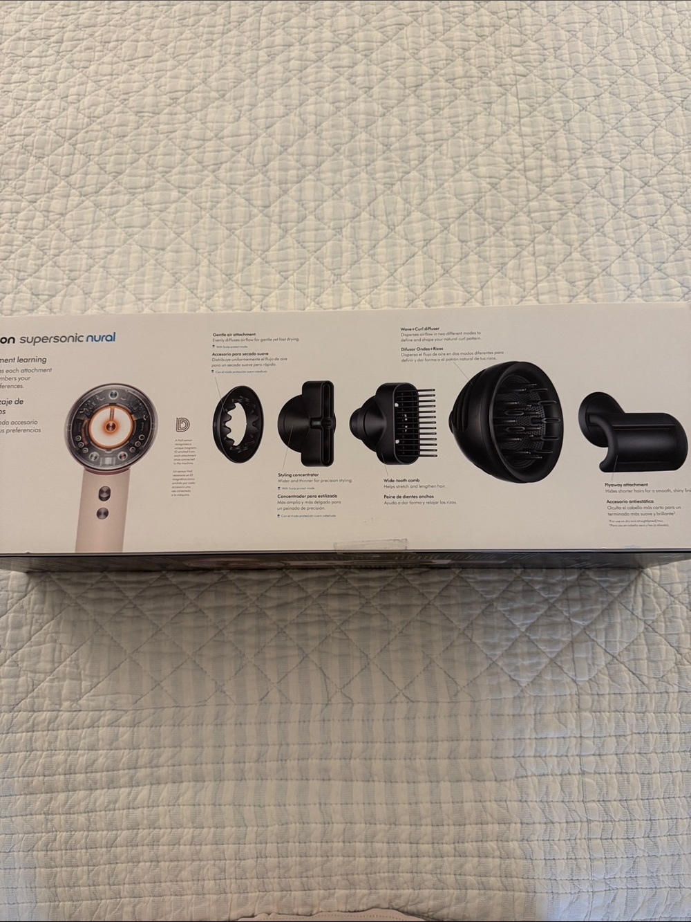 Dyson hair dryer kit in white with copper accent and black attachments